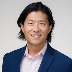Jiaye Jho - President pfm medical Inc. and Executive Director China A smiling man with medium-length black hair is wearing a blue suit jacket over a light pink shirt. He is facing the camera against a neutral background, projecting a confident and approachable demeanor.