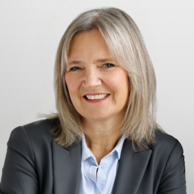 Janine Schoeller - Vice President China & APAC A smiling woman with shoulder-length gray hair is wearing a black blazer over a light blue shirt. She is facing the camera against a neutral background, conveying a friendly and professional demeanor.